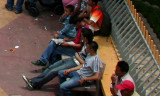 These people were watching the demonstration from the sideline of the park bench.