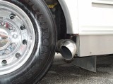 THE DETROITS EXHAUST EXITS IN FRONT OF THE RIGHT WHEEL OF THE AIR RIDE DRIVE AXLE FROM A FREIGHTLINER TRUCK