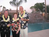 Jim & Bev Edmundson, Gordon Lindstrom in front of Alans beautiful pool .  The rock slide and misters made it look very tropical
