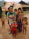 Older girls looking after children while parents work in the forest
