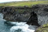 Sea caved in the base of the cliff at Arnastapi