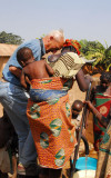 Udo Stark drawing water from the well as villagers watch