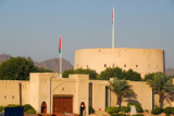 Gate to Nizwa Souq with the massive tower of Nizwa Fort