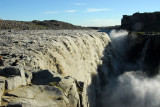 The cold, gray color of the water at Dettifoss is due to sediment from glacial water