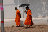 Monks with an umbrella in Vientiane