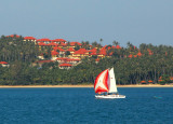 Sail boat passing one of the new real estate developments on Koh Samui