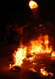 A bale of burning straw is kicked high in the air