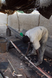 Man building a pirogue, Gao