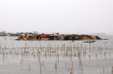 Fish farming by an island village, Lac Ahm, Bnin
