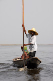 Boy poling the canoe back towards Ganvie