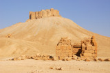 Ruins of an ancient tomb at the base of the volcanic cone