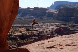 Young woman sailing over sandstone