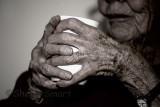 Elderly hands on cup