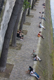 People sitting on banks of  Seine