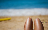 Legs of sunbaker at beach