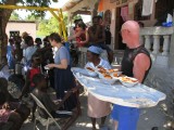 passing out bread, spaghetti sauce and fruit to the locals that hung out at our place every day