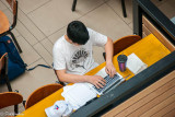Student at Work in Cafe