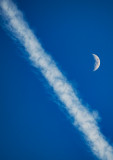 Moon over contrail