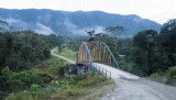Shaman on toucan bridge over Ro Nangaritza