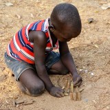 Child playing with bullets, Itang, Ethipoia