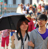 Happy tourists in the San Marco Square. Open your umbrella against the hot sunny day!