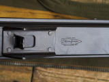 Savage receiver top showing Thompson bullet logo and protected rear sight