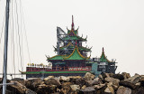 Giant floating restaurant Jumbo beyond the seawall being towed out to sea 