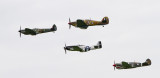 Super Marine Spitfire, Hawker Hurricane, P-51 Mustang and P-40 Warhawk.  This is an actual shot, with a bright gray cloud.