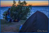 Campers Roasting Marshmallows At Sunset  