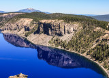 Crater Lake rim reflected in the deep blue waters in Crater Lake National Park