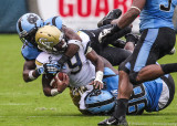 Yellow Jackets A-back Zenon is gang tackled by Tar Heels defenders