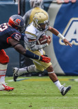 Yellow Jackets QB Thomas tries to escape the grasp of Cuse NT Eric Crume