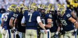 Pitt offense huddles before the snap