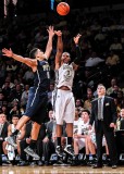 Tech F Georges-Hunt shoots the three over Panthers G Robinson as Coach Gregory looks on