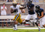 Yellow Jackets A-back Charles Perkins outruns two Eagles defenders