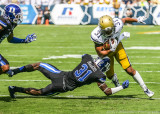 Jackets A-back Deon Hill runs through the tackle of Blue Devils CB Breon Borders