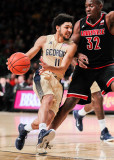 Yellow Jackets G Heath drives into the lane past Cardinals F Chinanu Onuaku