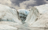 A stream cuts through the ice on Root Glacier in Wrangell-St Elias National Park