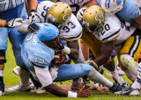 Yellow Jackets defense tackles a helmetless Heels QB Williams