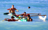 Ocean swell engulfs an Outrigger Canoe in the waters off of Waikiki Beach