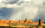 Snow falling beyond the Windows Section in Arches National Park