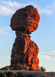 The sun setting on Balanced Rock in Arches National Park
