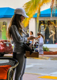 Cigar girl texting along Ocean Drive on South Beach