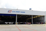 Coast Guard Day Picnic attendees dining on a variety of goodies inside the fixed-wing hangar at Air Station Miami