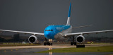 Aerolineas Argentinas Airbus A330-223 LV-FNJ taxiing in after landing on runway 27 before a storm aviation airline stock photo
