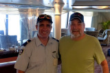 Howard with Pitcairn policeman from New Zealand. Howard bought a police patch for Al.