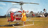 1950's - Ellen M. Gilmore, owner and pilot, posing with a Sky Lark Bell 47 helicopter at Watson Island
