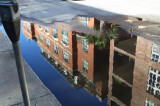 City Block reflected in Street Puddle, Charleston, SC., USA.