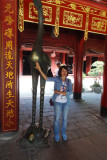 Minh rubbing the belly of the phoenix for luck - Temple of Lecture, Hanoi, Vietnam