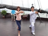 Judy learning T'ai Chi aboard the Treasure Junk in Ha Long Bay, Vietnam